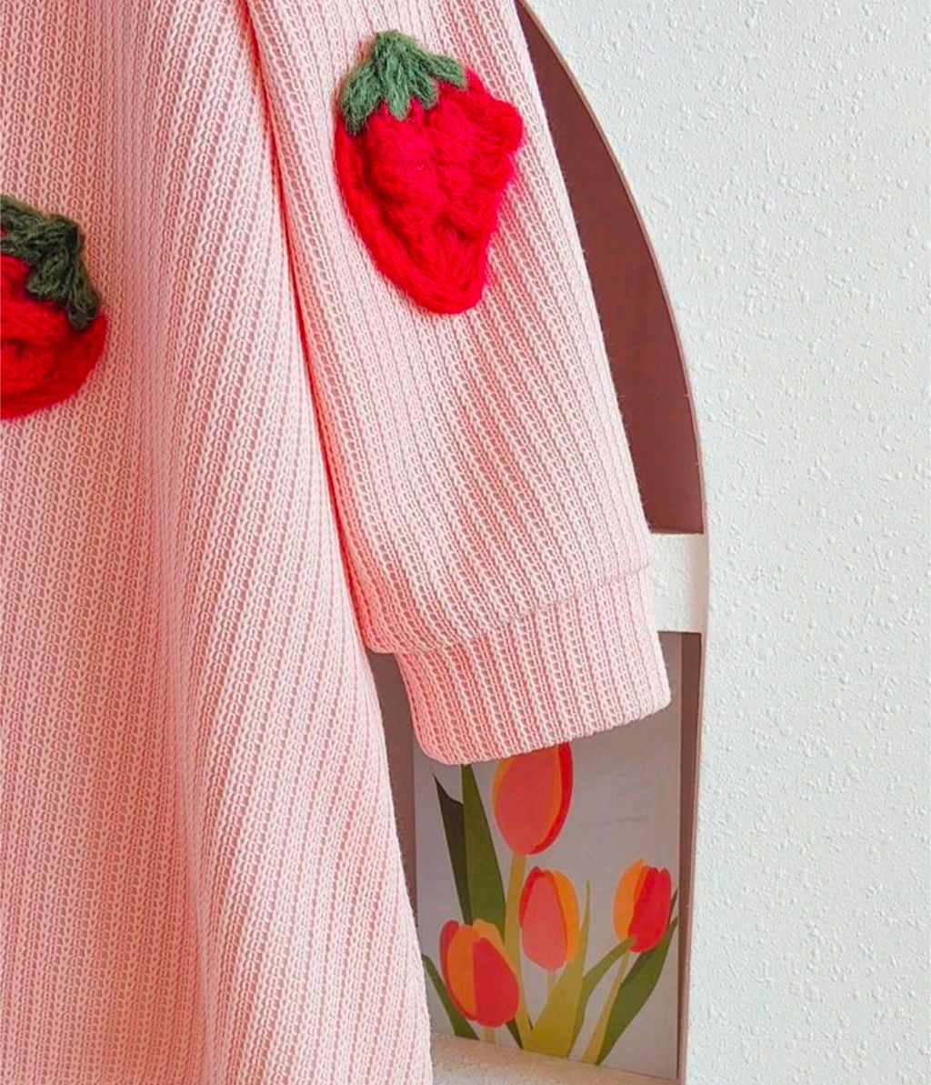 Child wearing the pink strawberry dress