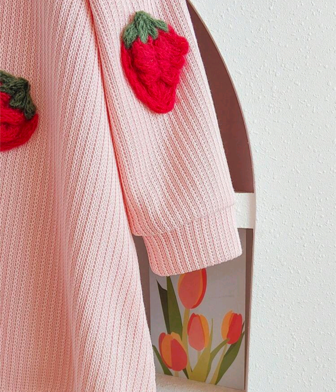 Child wearing the pink strawberry dress