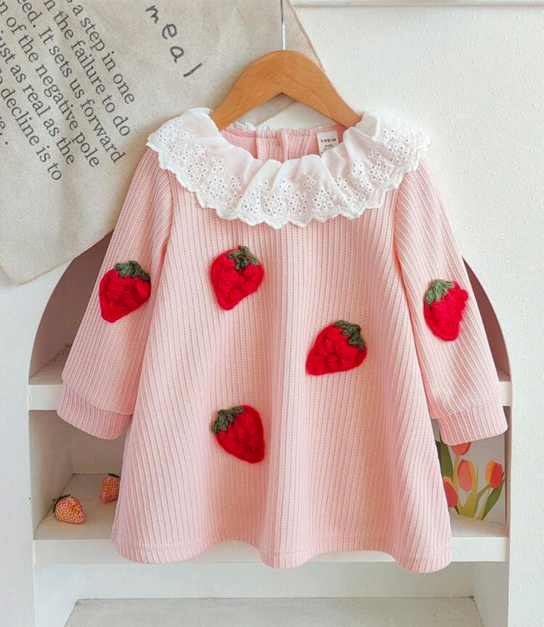 Pink strawberry dress with white eyelet ruffle collar, front view