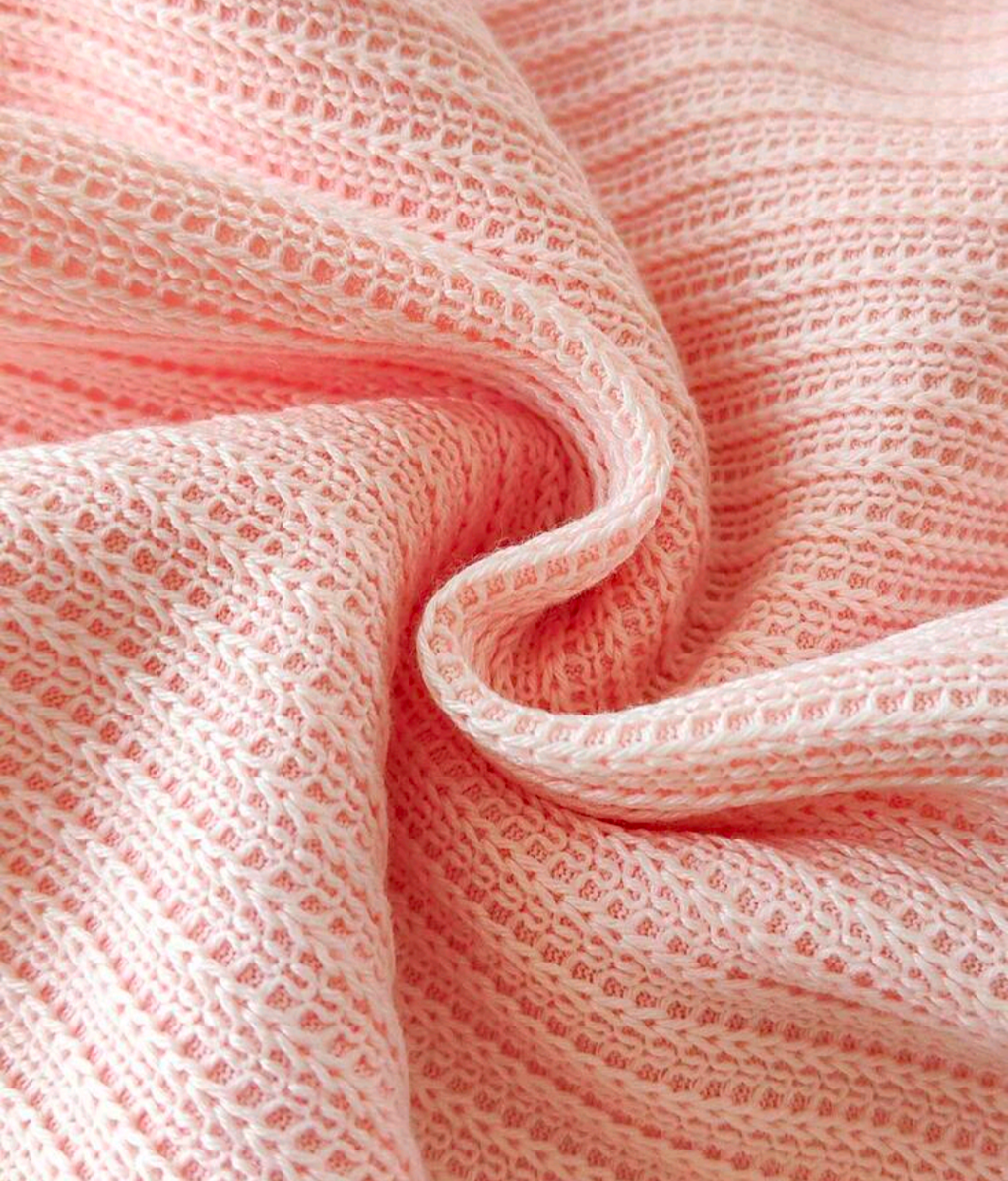 Close-up of textured pink dress fabric