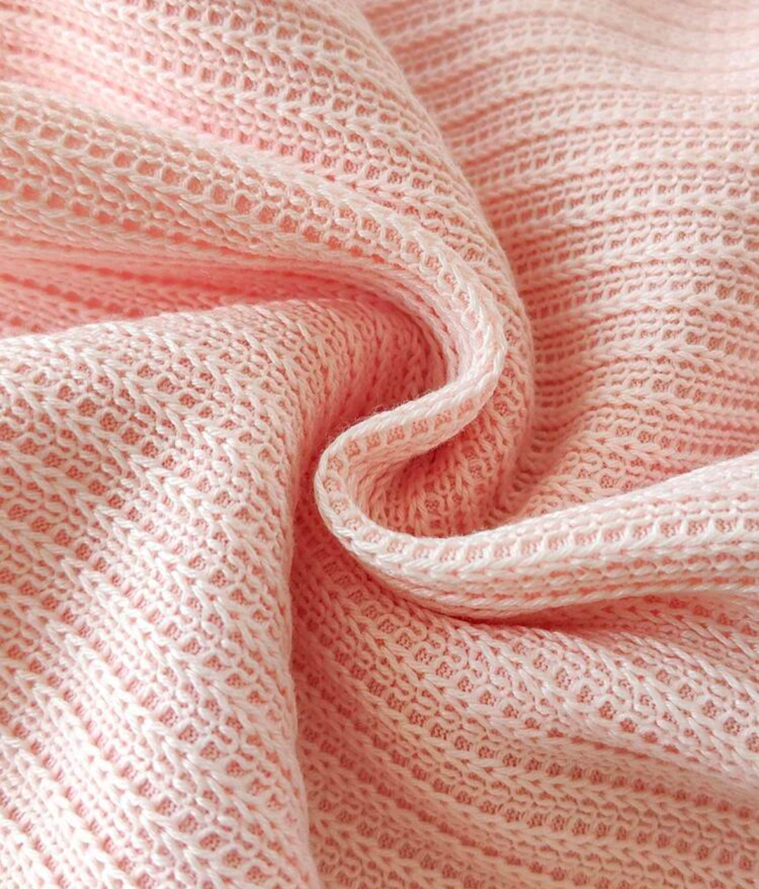 Close-up of textured pink dress fabric